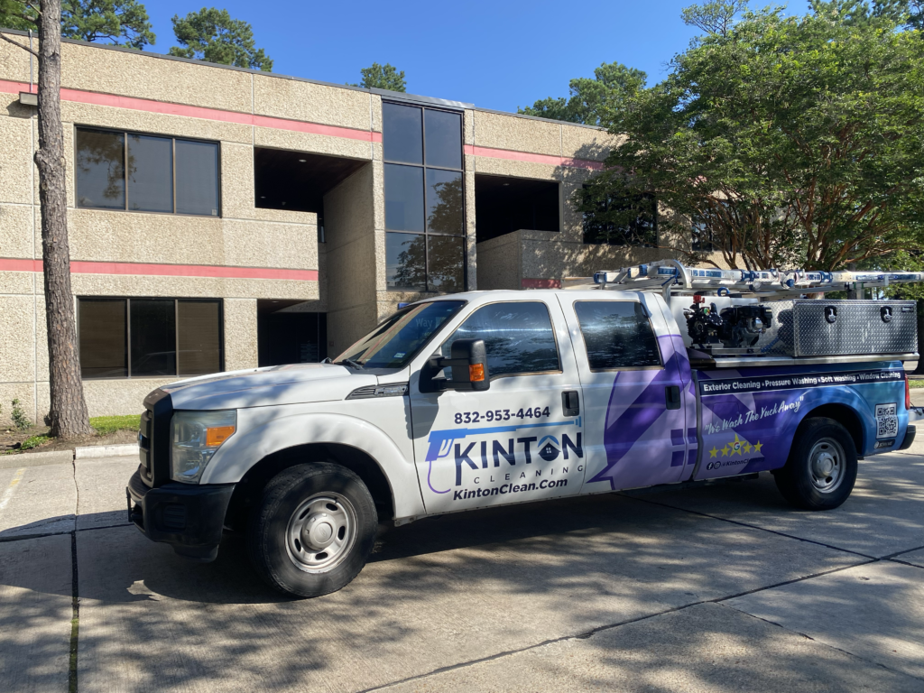 Kinton Pressure Washing and Cleaning parked in front of an office building in The Woodlands, TX. 